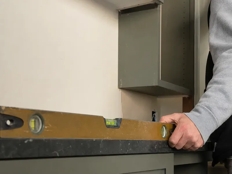 Custom cabinets in Boise Id — a level held against a finished surface with the bubble dead centre
