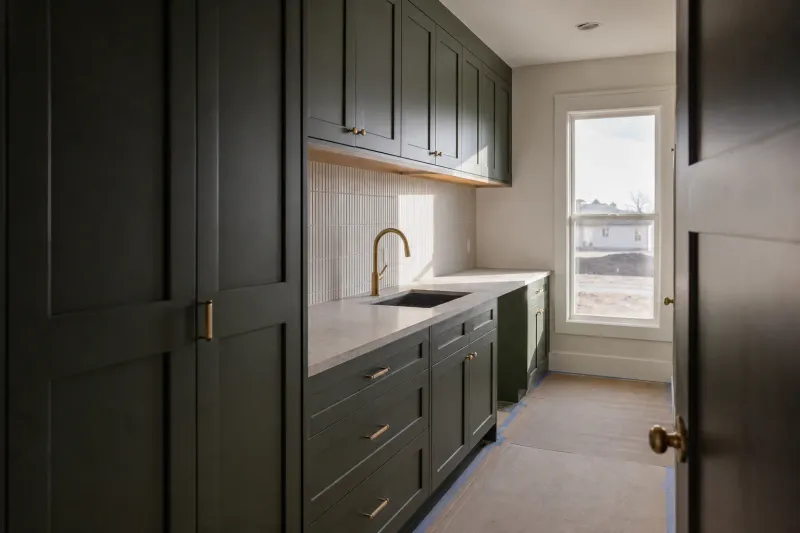 Custom cabinets laundry room — low sun raking down a hallway to show how flat the finished surface is