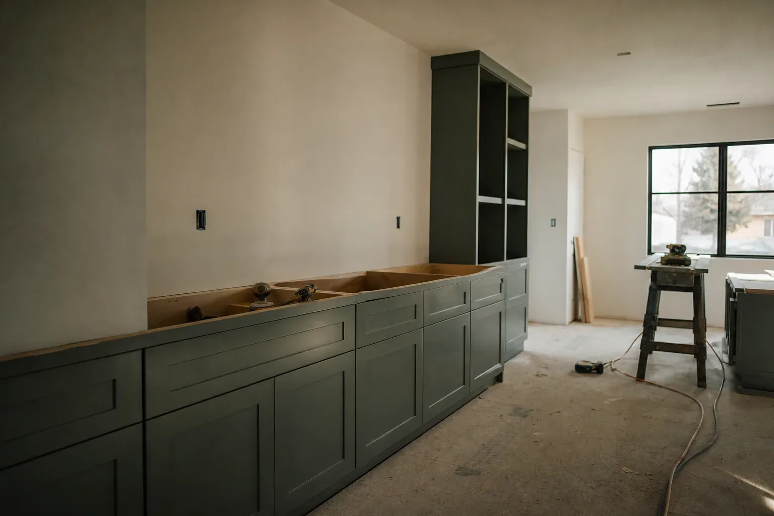 Custom cabinets in Nampa Id — clean lines of finished wall running toward the window of a small commercial suite